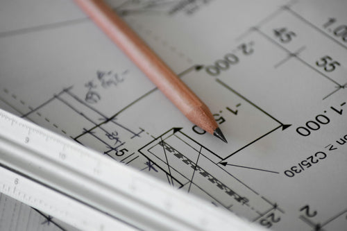 Architectural drawings and pencil on desk — local area planning application review england